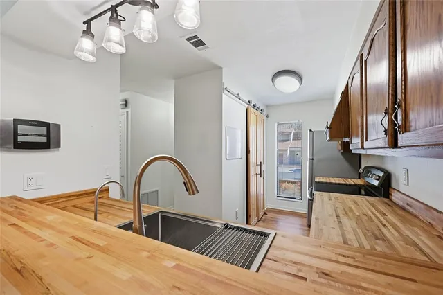 a bedroom with a bed and a large mirror on the dresser