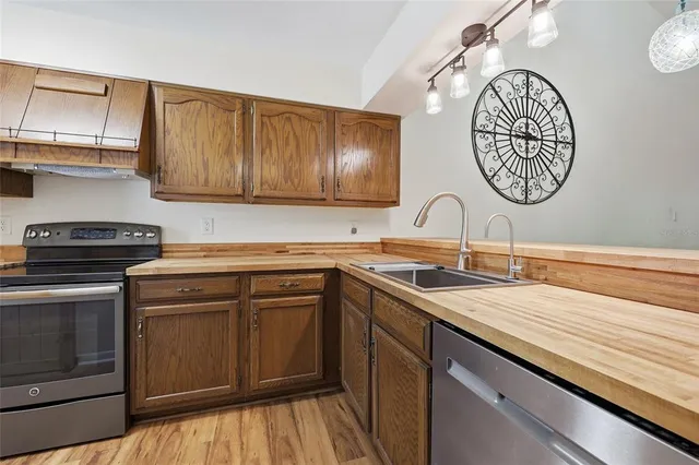 a kitchen with a sink cabinets and stainless steel appliances