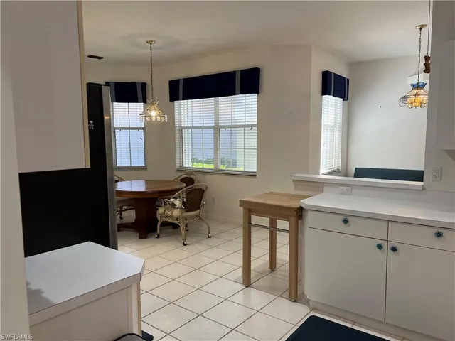 a kitchen with a refrigerator and a sink