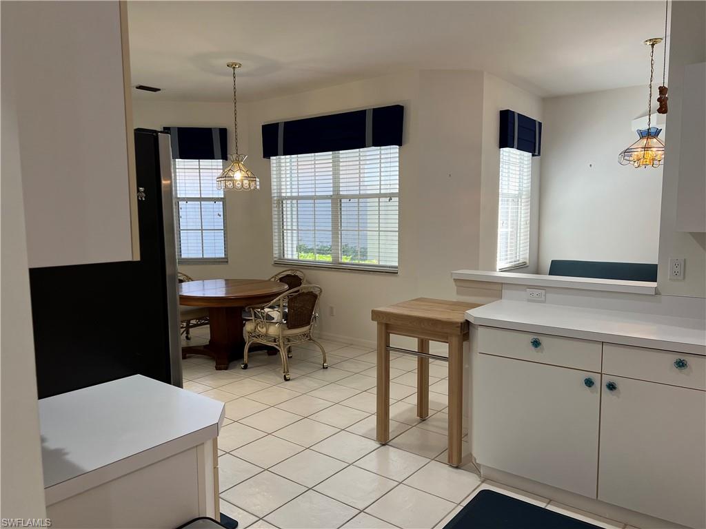 2081 Crestview Way, Unit A7 Naples, FL 34119 - Photo 11 of 33 a kitchen that has a sink and a table in it