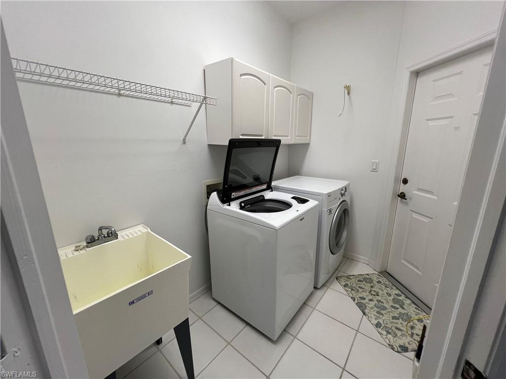 2081 Crestview Way, Unit A7 Naples, FL 34119 - Photo 14 of 33 a utility room with dryer and washer