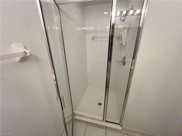 wooden floor in a room with a chandelier