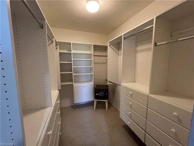 a bathroom with a granite countertop shower and a toilet