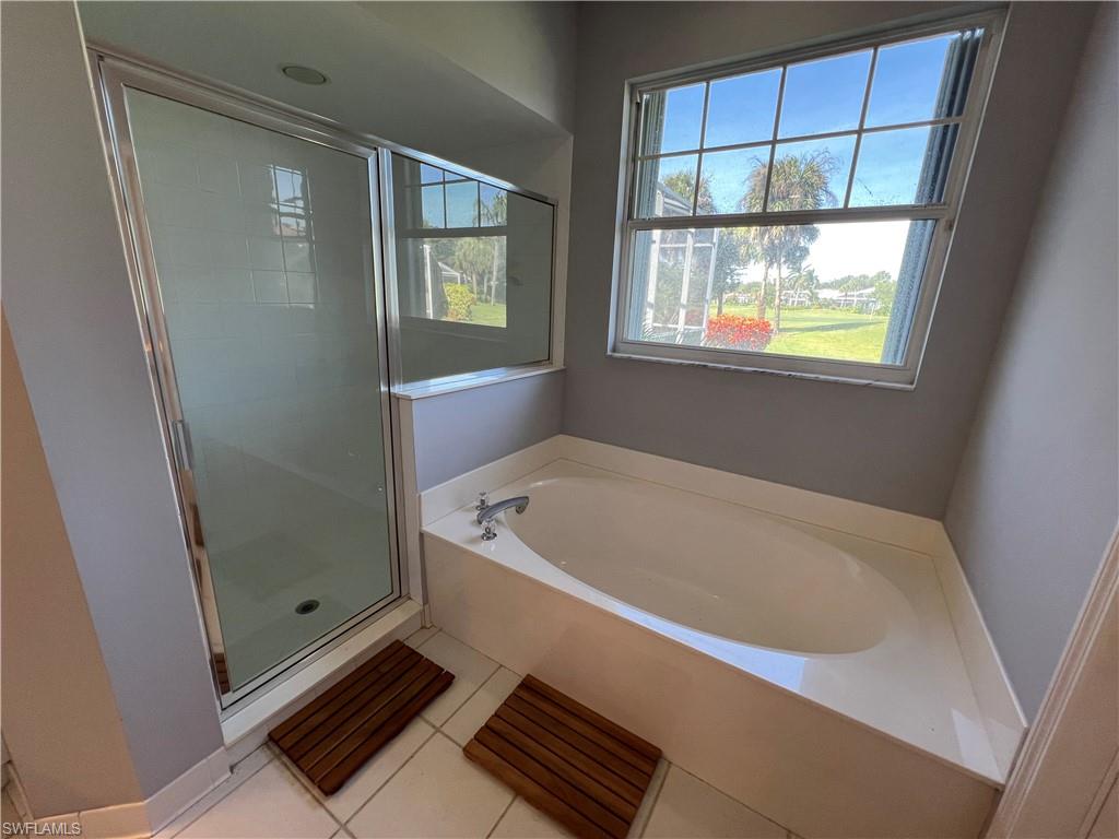 2081 Crestview Way, Unit A7 Naples, FL 34119 - Photo 28 of 33 a bath tub sitting next to a window
