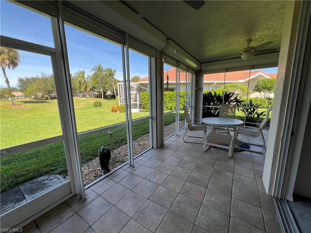 2081 Crestview Way, Unit A7 Naples, FL 34119 - Photo 30 of 33 a view of a porch with chairs and backyard