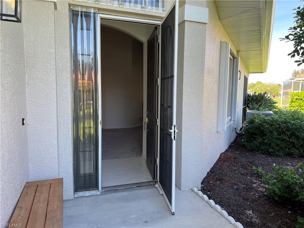 2081 Crestview Way, Unit A7 Naples, FL 34119 - Photo 5 of 33 a view of a entryway door of the house
