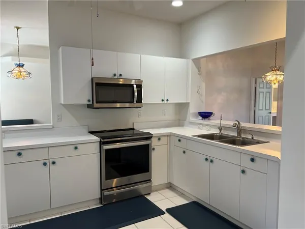 a kitchen that has a sink and a table in it