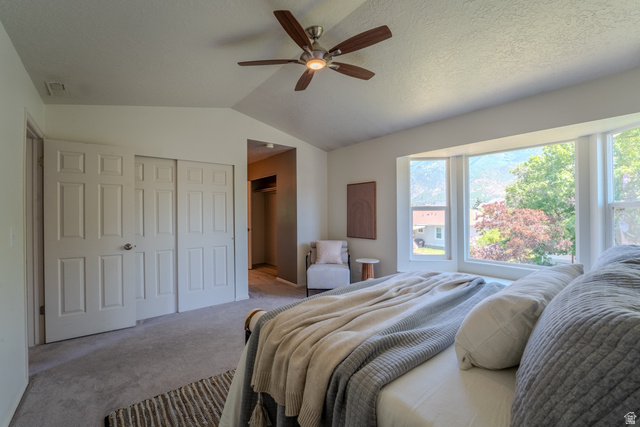 11957 Noelle Road Sandy, UT 84092 - Photo 17 of 38 Bedroom featuring a vaulted ceiling with a ceiling fan, a large bay window, and carpet flooring