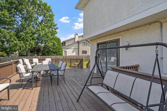 a view of a roof deck with table and chairs