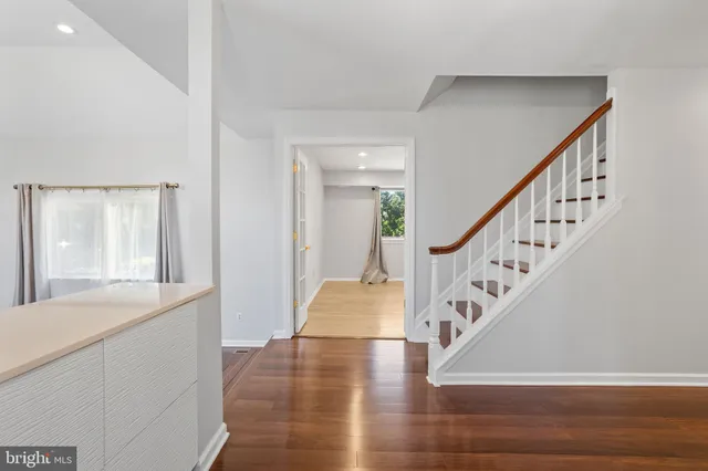 a view of entryway and hall with wooden floor