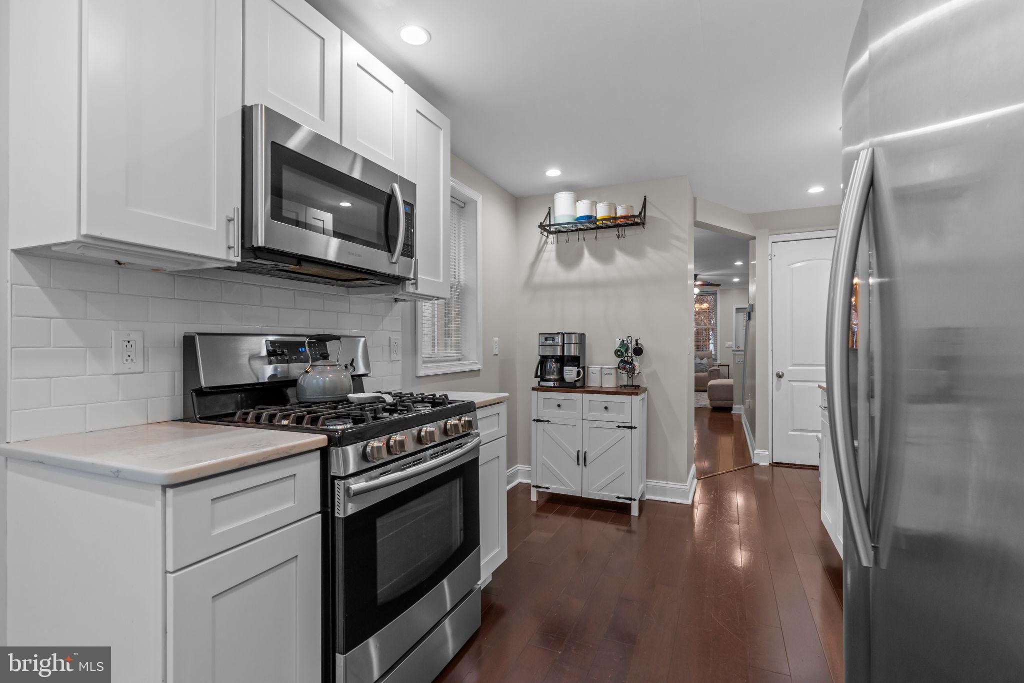 3554 New Queen Street Philadelphia, PA 19129 - Photo 12 of 39 a kitchen with stainless steel appliances a stove microwave and a refrigerator