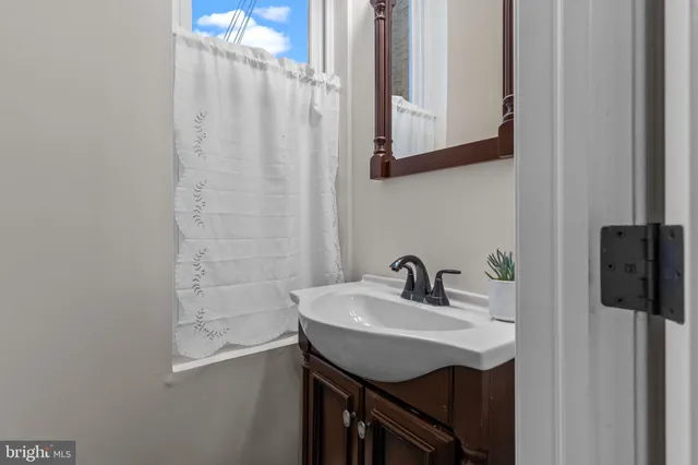 a view of staircase with railing and white walls