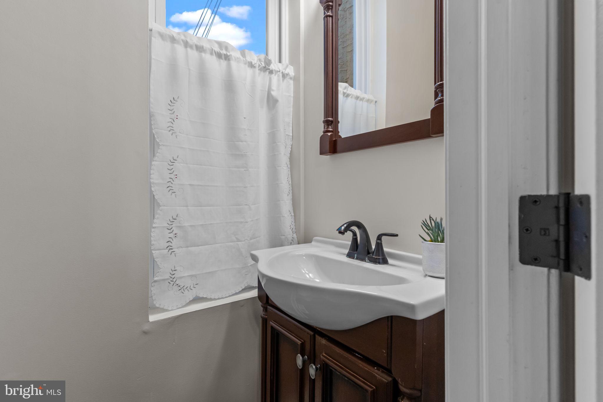 3554 New Queen Street Philadelphia, PA 19129 - Photo 14 of 39 a bathroom with a sink and a mirror