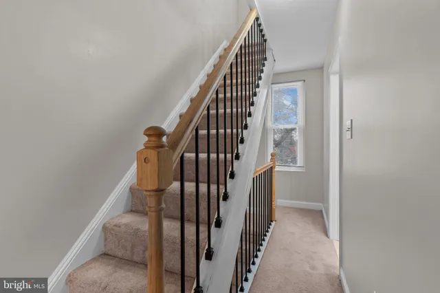 a bedroom with a large bed and a flat tv screen on dresser