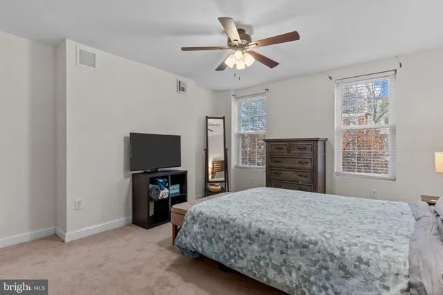 a bedroom with a bed and a dresser in it