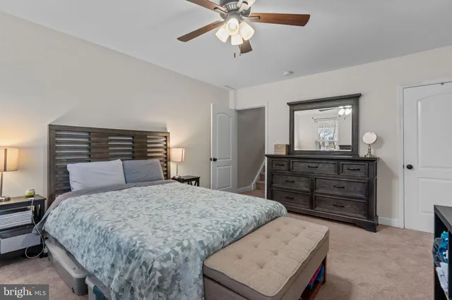 a utility room with dryer washer and a view of bedroom