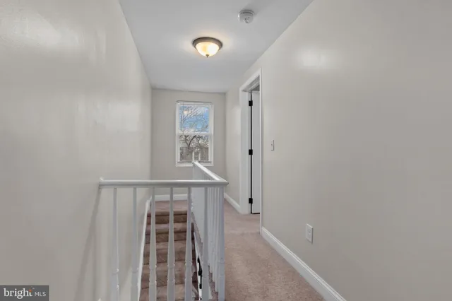 a bedroom with bed a chandelier and a window