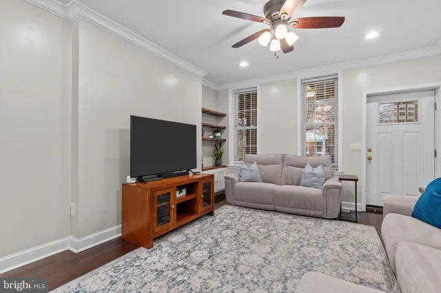 a view of a livingroom with furniture hardwood floor and hallway