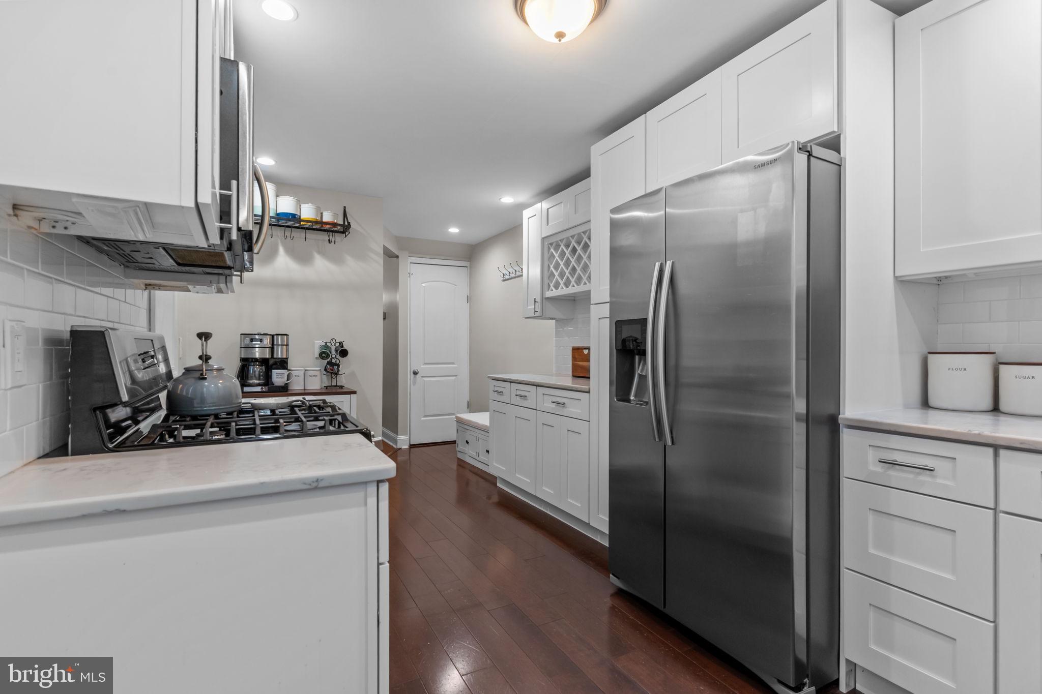 3554 New Queen Street Philadelphia, PA 19129 - Photo 10 of 39 a kitchen with stainless steel appliances a refrigerator a sink a stove and cabinets