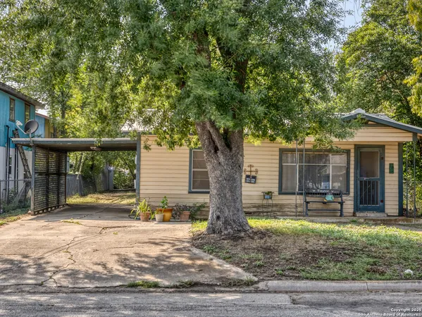 a view of a house with backyard and sitting area