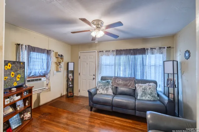 a living room with furniture and a flat screen tv