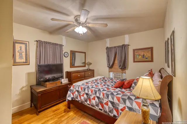 a bedroom with a bed flat screen tv and a couch