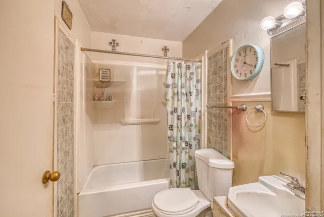 a white toilet sitting next to a bathroom sink