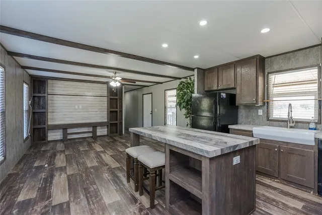 a view of kitchen with granite countertop window and wooden floor