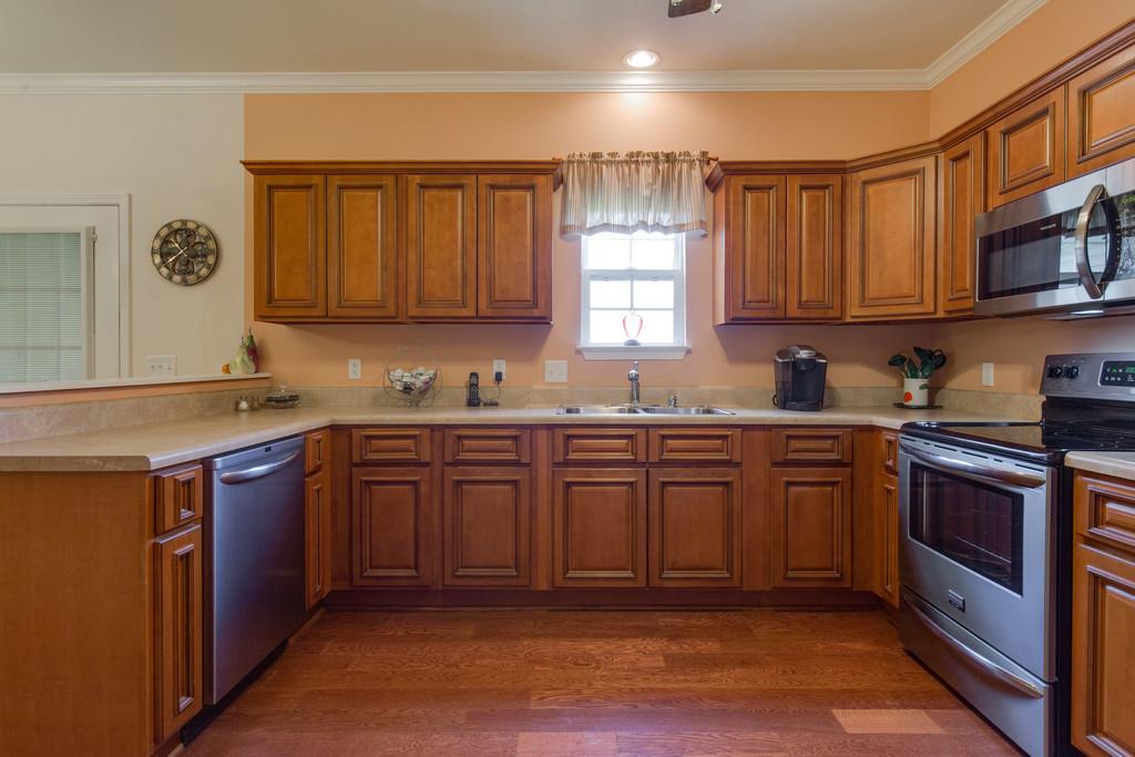 403 Coker Ford Road Portland, TN 37148 - Photo 11 of 29 a kitchen with granite countertop a sink cabinets stainless steel appliances and a window
