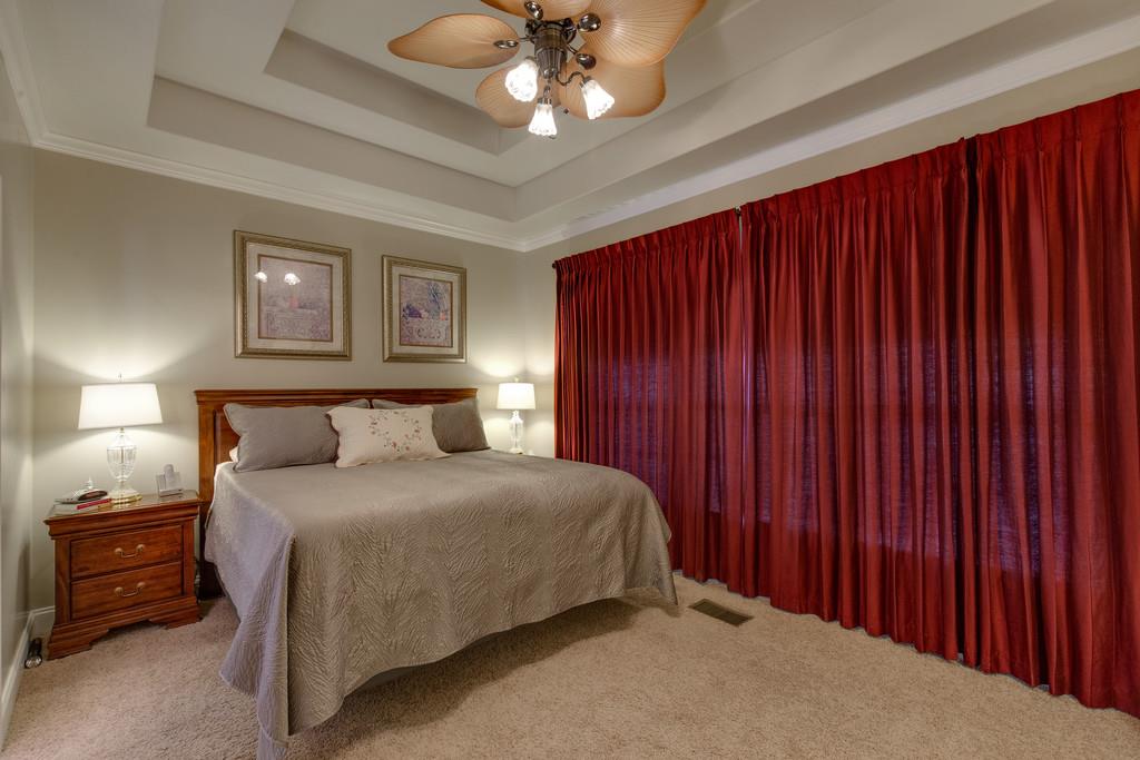 403 Coker Ford Road Portland, TN 37148 - Photo 12 of 29 a bedroom with a bed and a chandelier