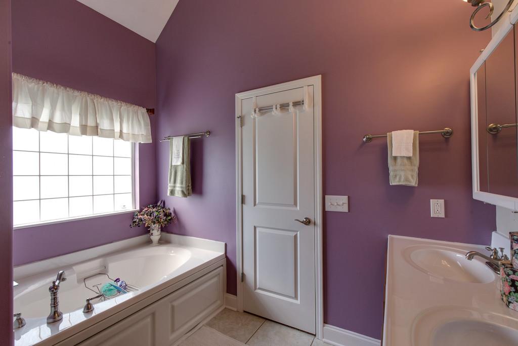 403 Coker Ford Road Portland, TN 37148 - Photo 15 of 29 a bathroom with a tub sink and mirror