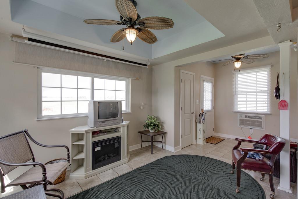 403 Coker Ford Road Portland, TN 37148 - Photo 22 of 29 a living room with furniture a fireplace and a flat screen tv
