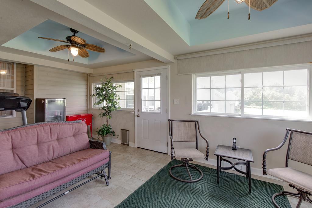 403 Coker Ford Road Portland, TN 37148 - Photo 23 of 29 a living room with furniture a chandelier fan and a window
