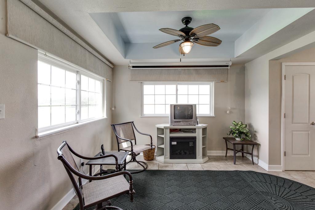 403 Coker Ford Road Portland, TN 37148 - Photo 24 of 29 a living room with furniture a fireplace and a flat screen tv