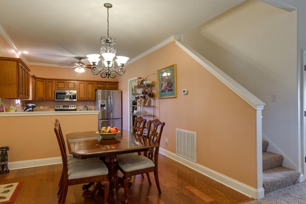 403 Coker Ford Road Portland, TN 37148 - Photo 7 of 29 a dining room with furniture a chandelier and wooden floor