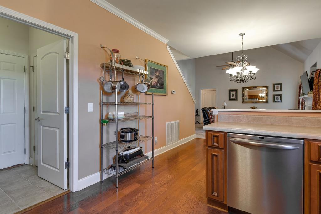 403 Coker Ford Road Portland, TN 37148 - Photo 10 of 29 a view of a hallway to room with wooden floor and chandelier