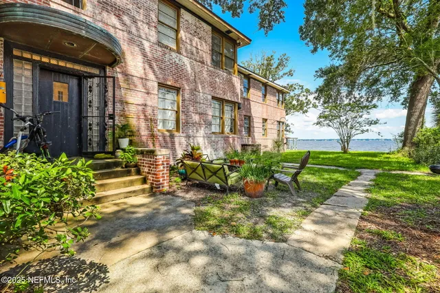 a view of a chair and tables in the patio of the house