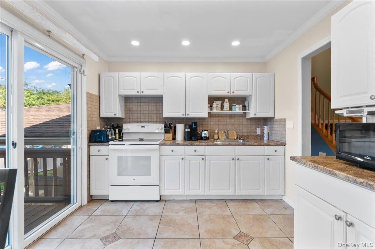 21 Eleanor Road Plainview, NY 11803 - Photo 11 of 39 a kitchen with cabinets appliances and a counter top space