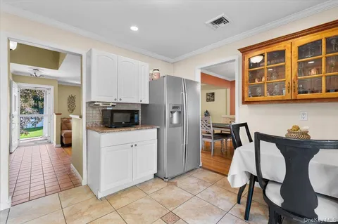 a kitchen with stainless steel appliances kitchen island granite countertop a refrigerator and cabinets