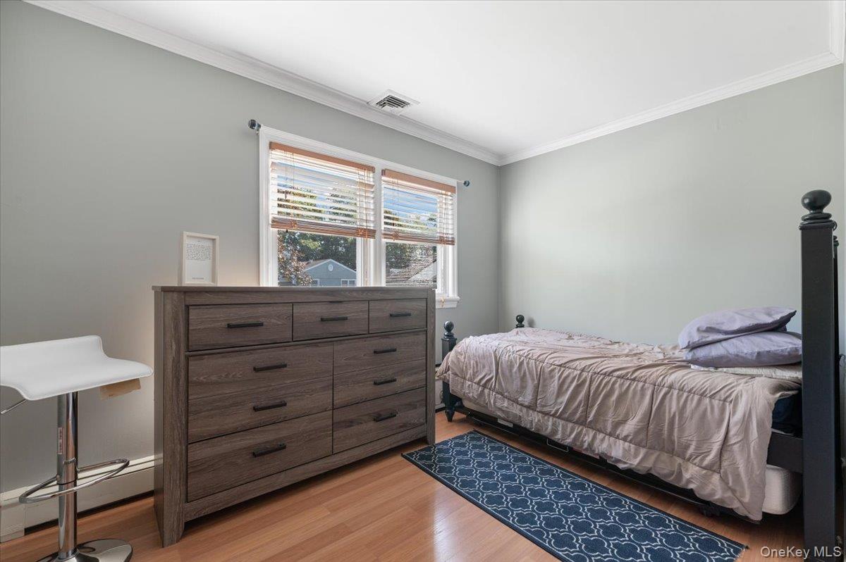 21 Eleanor Road Plainview, NY 11803 - Photo 15 of 39 a bedroom with a bed and a window