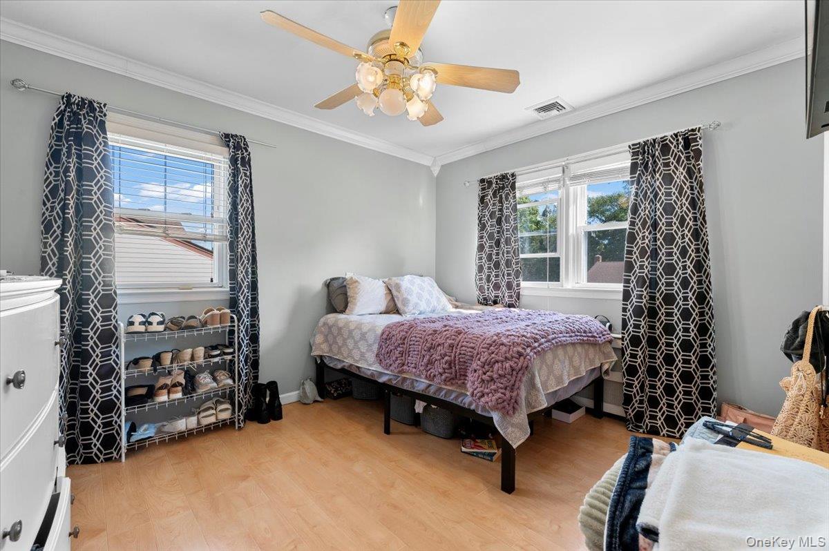 21 Eleanor Road Plainview, NY 11803 - Photo 16 of 39 a spacious bedroom with a bed and a window