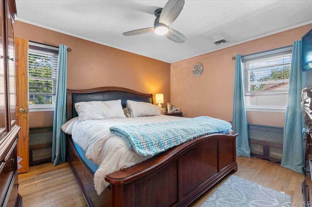 21 Eleanor Road Plainview, NY 11803 - Photo 17 of 39 a bedroom with a bed and a ceiling fan