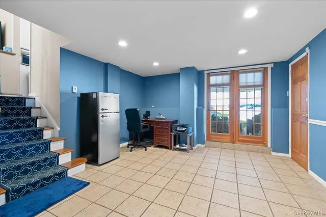 a view of kitchen with furniture and refrigerator