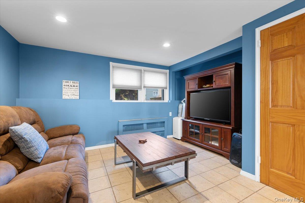 21 Eleanor Road Plainview, NY 11803 - Photo 19 of 39 a living room with furniture and a flat screen tv