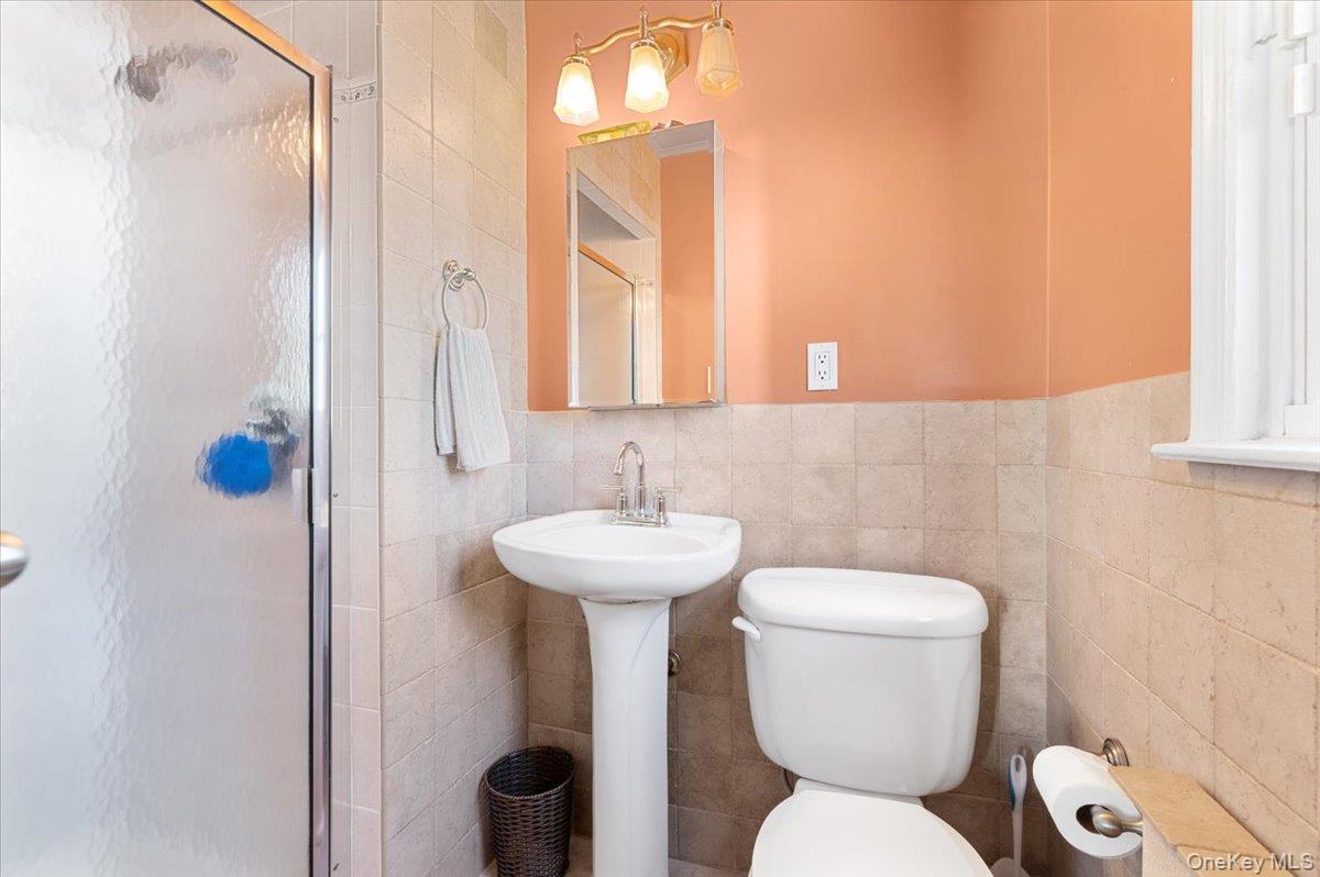 21 Eleanor Road Plainview, NY 11803 - Photo 22 of 39 a bathroom with a toilet sink and mirror