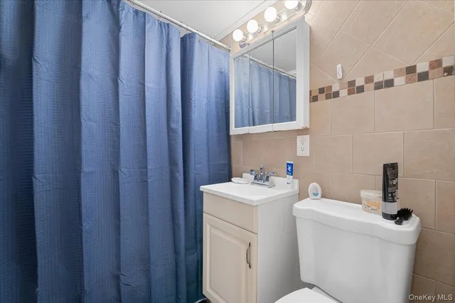 a bathroom with a sink a toilet and mirror