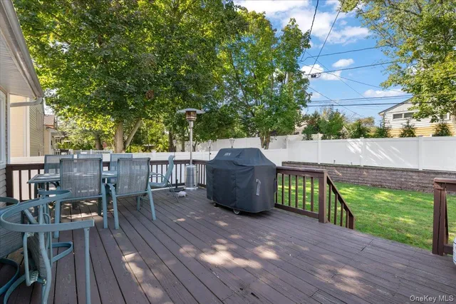 a view of a deck with table and chairs and wooden floor