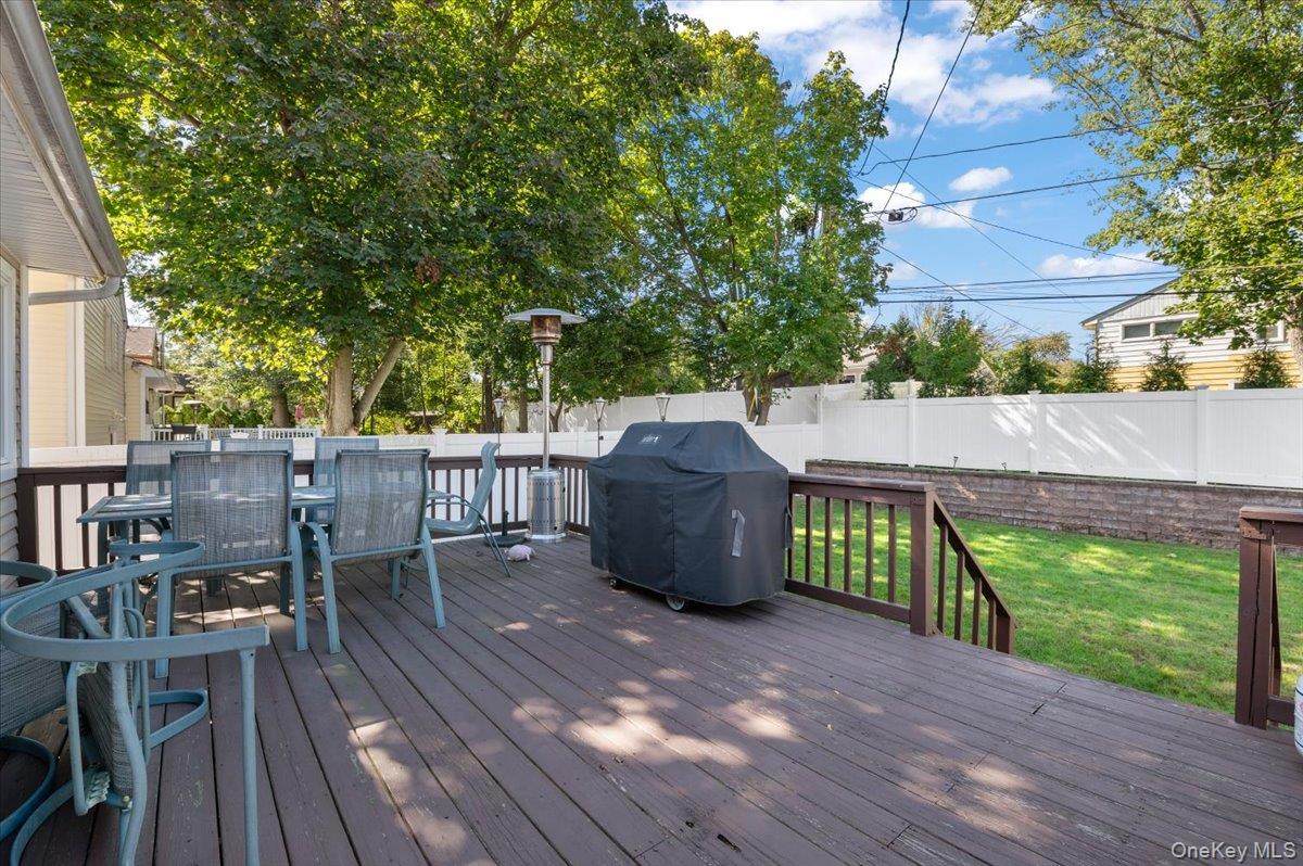 21 Eleanor Road Plainview, NY 11803 - Photo 30 of 39 a view of a deck with table and chairs and wooden floor