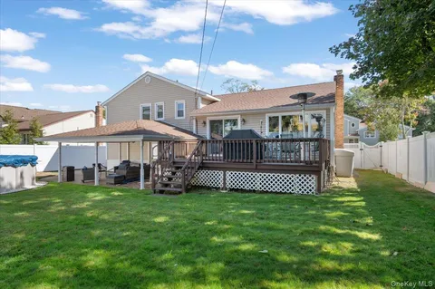 a view of a house with a yard and deck