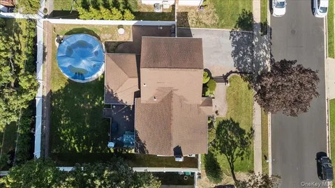 an aerial view of residential house with outdoor space and swimming pool